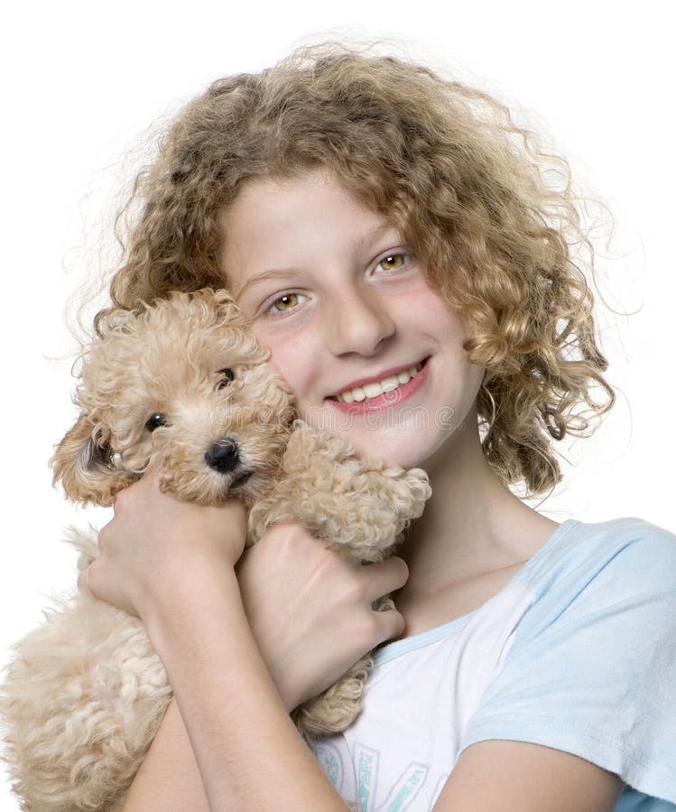 Young girl with her toy Poodle puppy (9 weeks old)