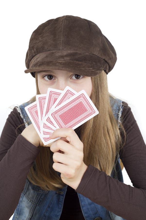 Young Girl Hiding Behind Playing Cards In Her Hand, Studio Shot Isolated On White Closeup