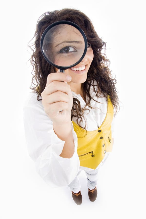 Young girl holding magnifier an