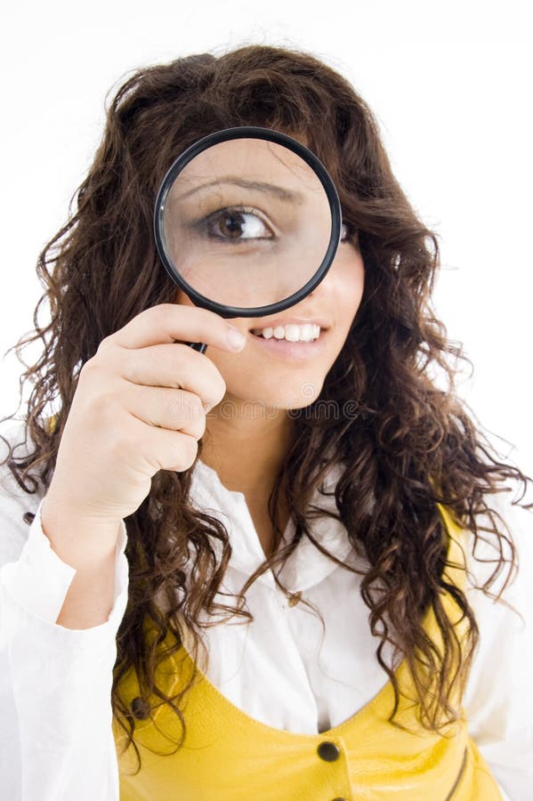 Young girl holding magnifier and showing