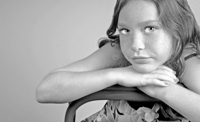 Young girl leaning on chair