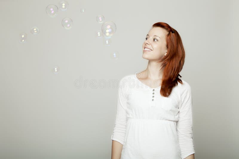 Young girl look to soap bubbles and dream