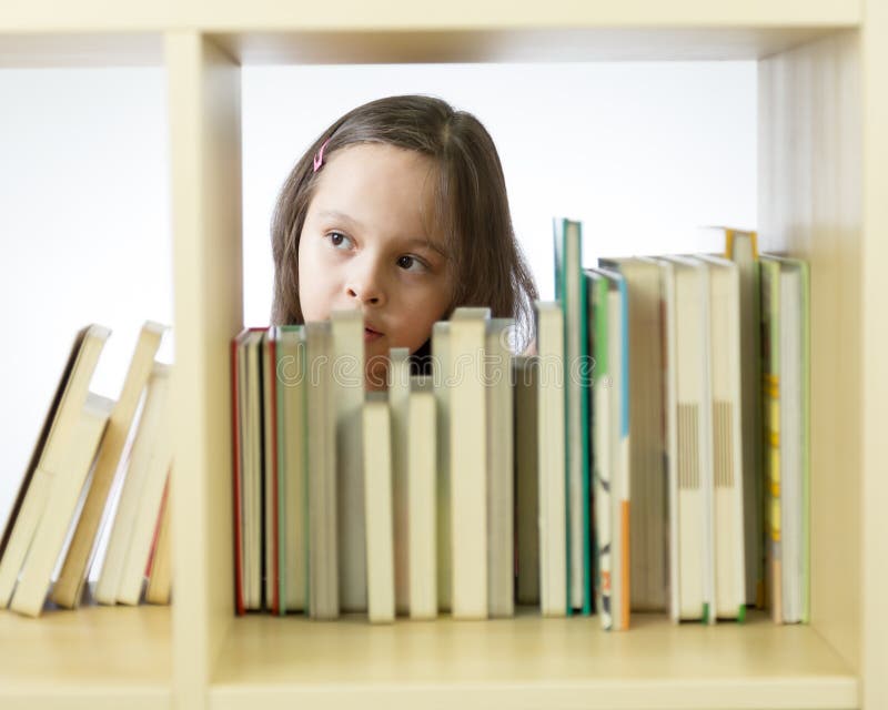 Young Girl Looking at Books on Bookshelf Stock Photo Image of