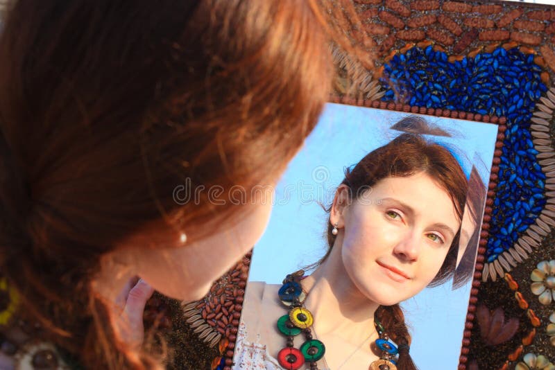 Young girl looking in the mirror