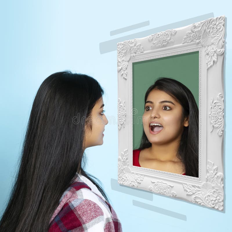 Young girl looking at mirror isolated on light background. Contemporary art collage. Concept of emotions, inner world stock photography