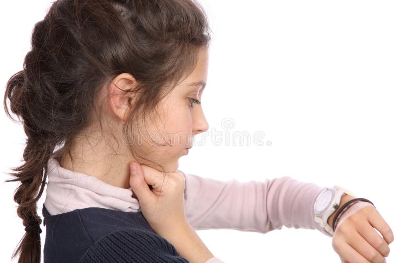 Young girl looking at watch royalty free stock photo