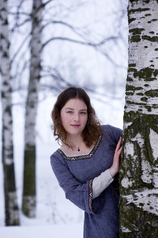 Young girl looks out from the tree