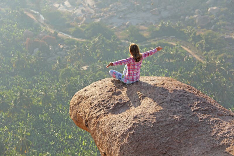 A young girl in a lotus pose is greeting the sun on a background royalty free stock photos A young girl in a lotus pose is greeting the sun on a background royalty free stock photos