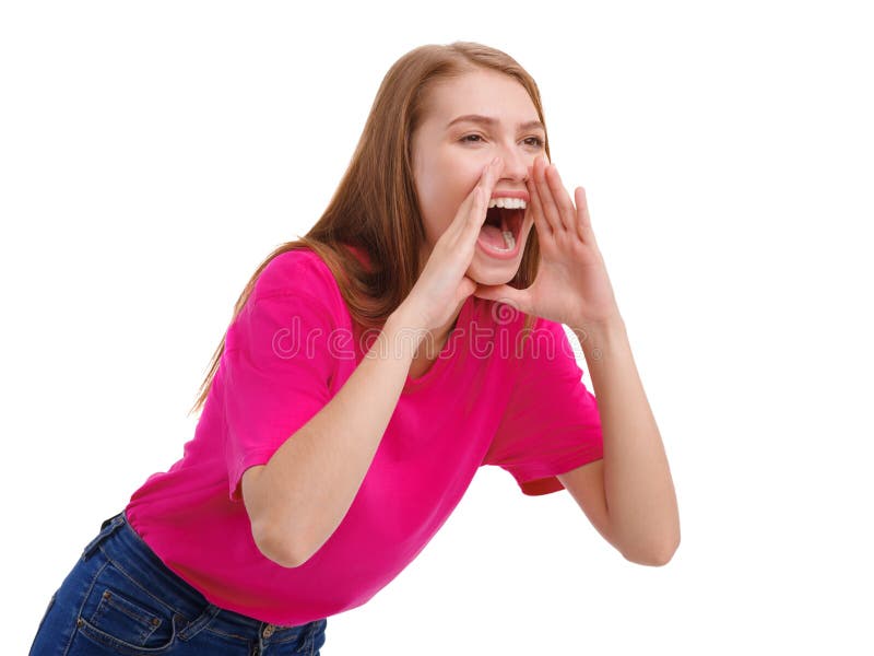 A young dark-haired girl in a pink T-shirt and jeans loudly screams wide open her mouth. Isolated on white background. A young dark-haired girl in a pink T-shirt and jeans loudly screams wide open her mouth. Isolated on white background.