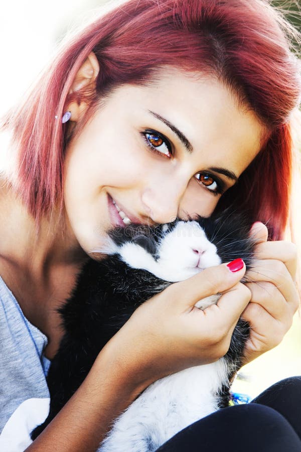 Young girl loving her bunny. Hugging and kissing