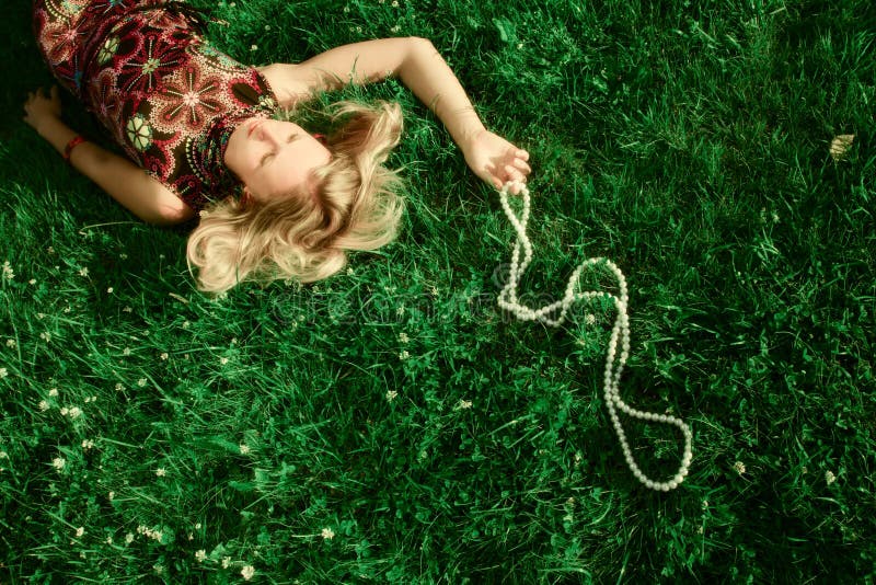 Young girl lying in grass