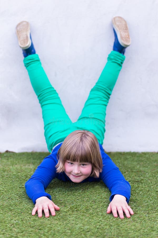 Young Girl Lying Upside Down Against Wall Stock Photos Free & Royalty