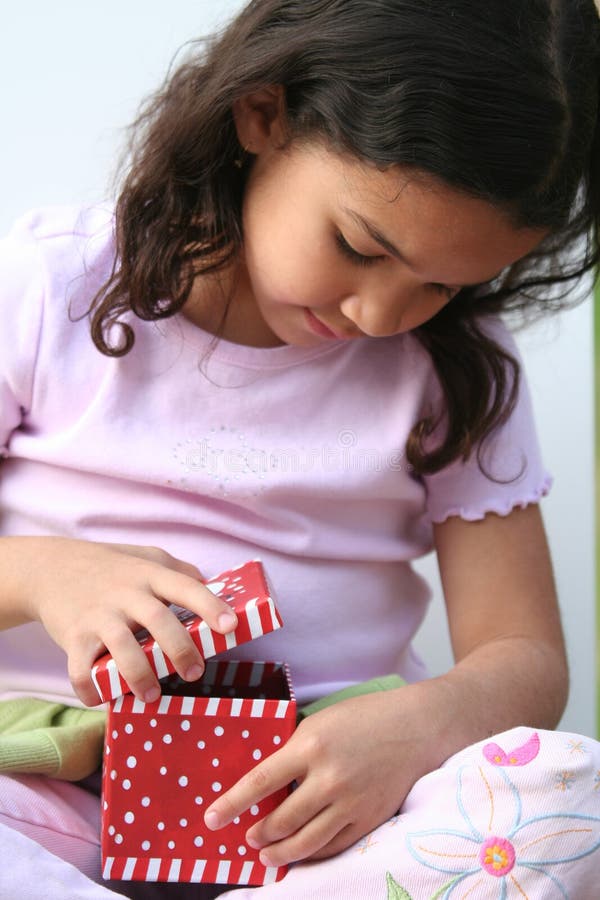 Young Girl Opening Present stock photos Young Girl Opening Present stock photos