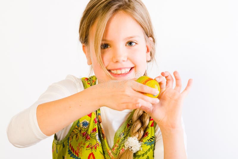 Young girl painting eggs