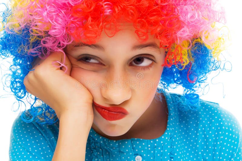 Beautiful young girl with party wig isolated on white background. Boring kid white stock images, royalty-free photos and pictures