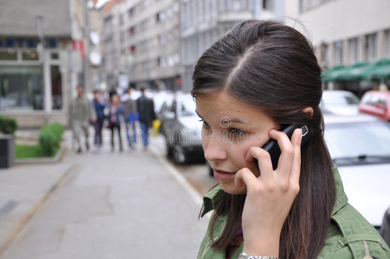 Young girl performs a call to a mobile phone