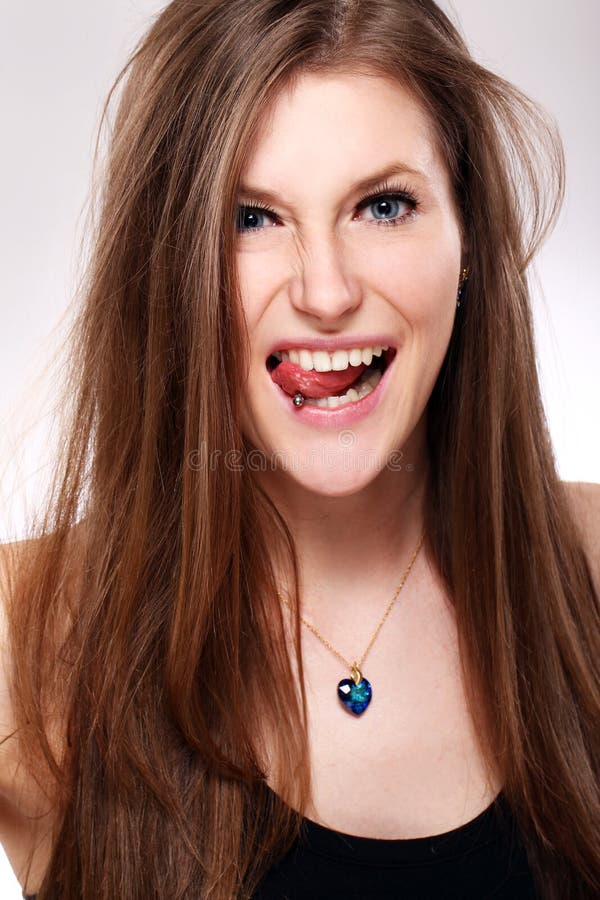 Young girl with piercing in tongue