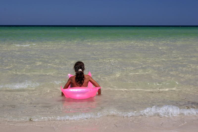 Young girl on pink air-bed in