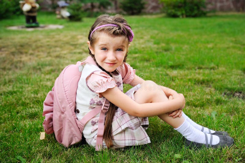 Young girl with pink bagpack ready for school