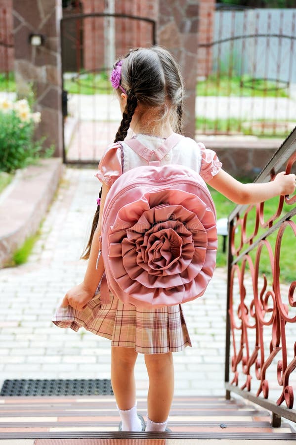 Young girl with pink bagpack ready for school