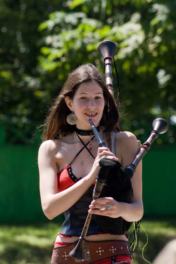Young girl playing the bagpipes.