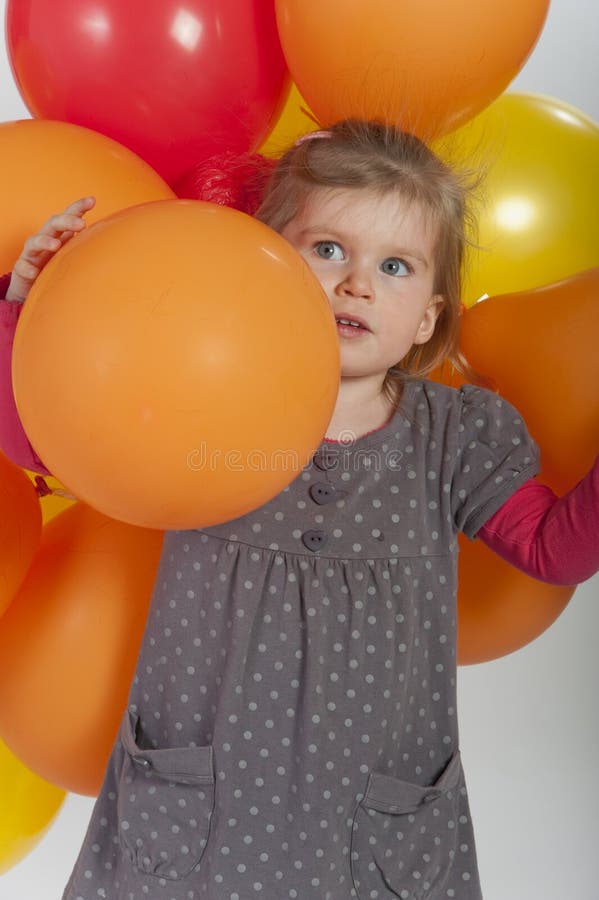 Young girl playing with balloons