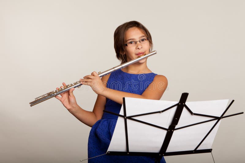 Young Girl Playing a Flute stock photo. Image of person 34792040