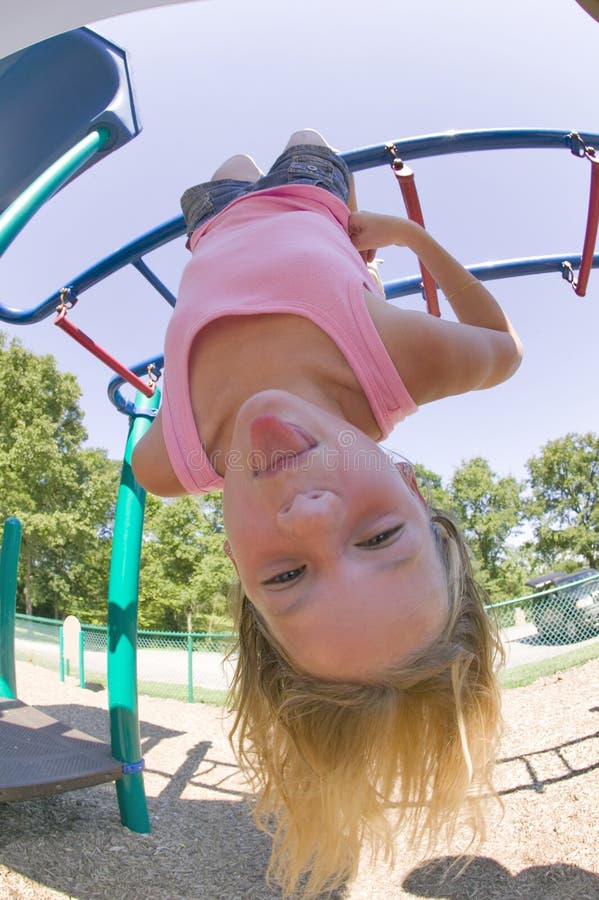 Young Girl Playing On Monkey Bars At The Park Stock 