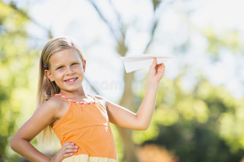 Young girl playing with a paper plane stock photos Young girl playing with a paper plane stock photos