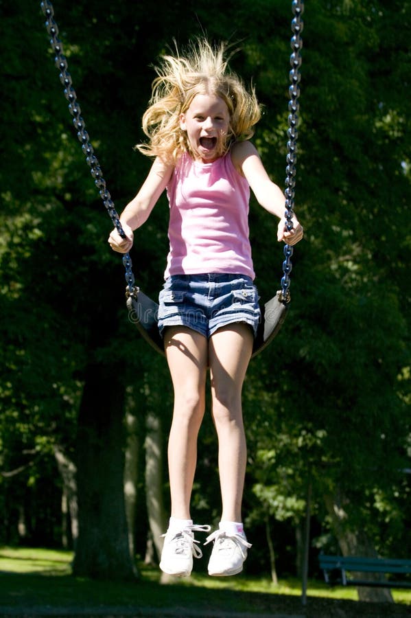 Young Girl Playing On A Swing Set At The Park Stock Photo Image 1130682