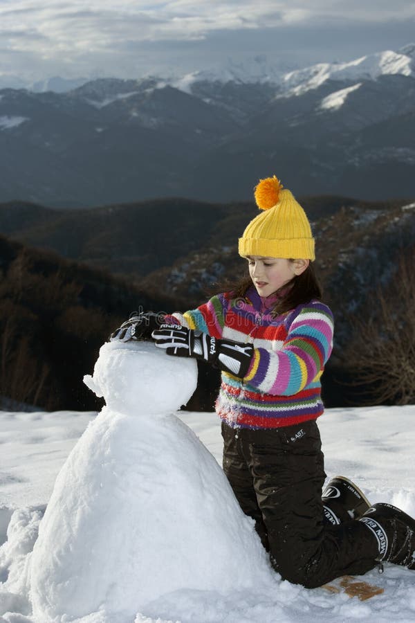 Young girl posing with her snowman