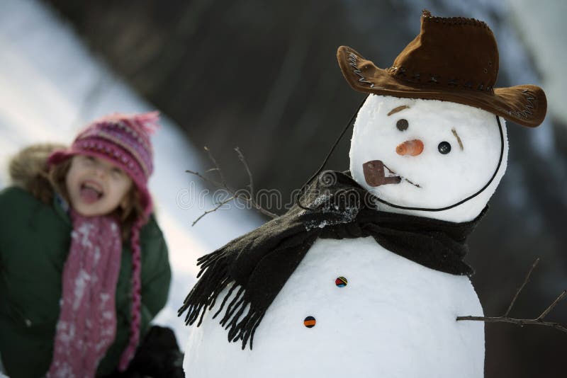 Young girl posing with her snowman