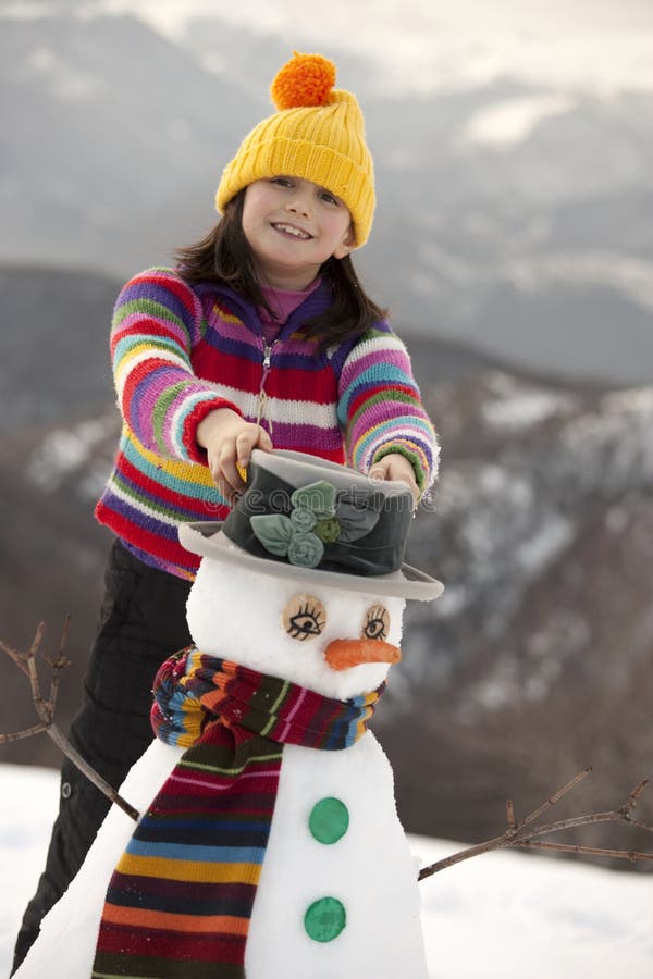 Young girl posing with her snowman