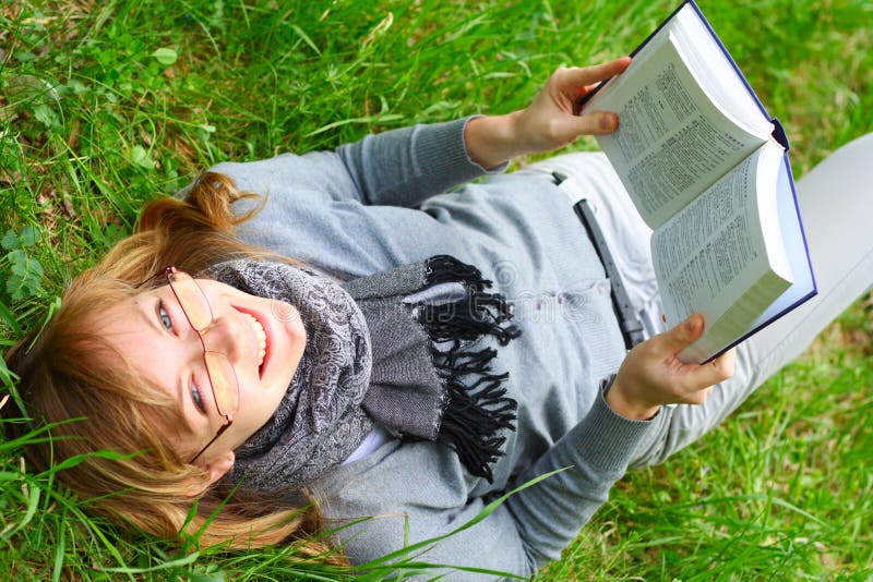 The young girl reads the book