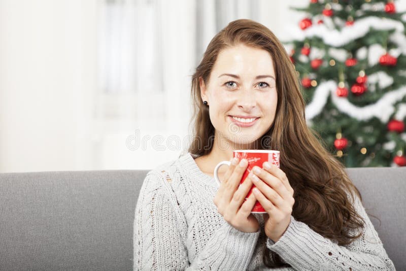 Young girl relaxing with warm tea at christmas