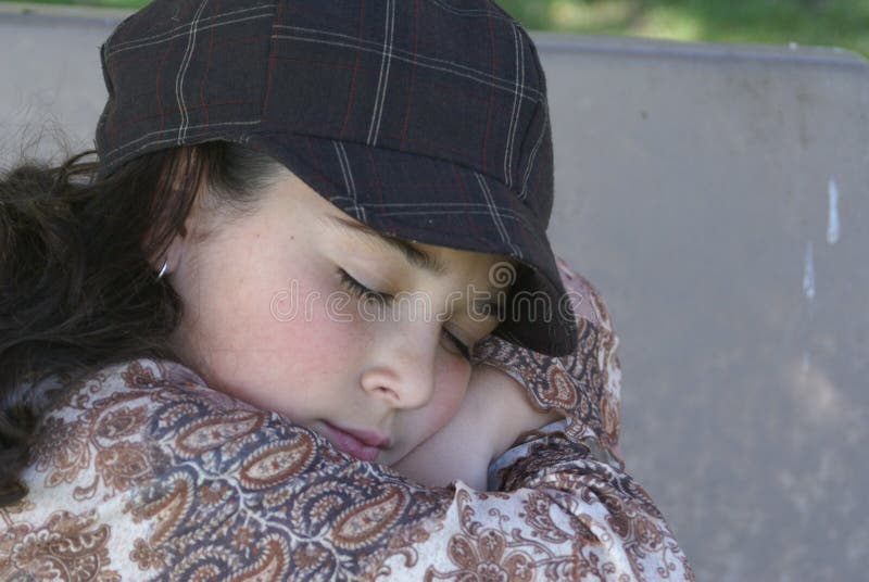 Young girl resting on park bench