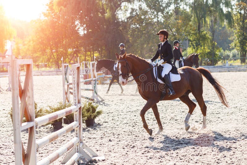 Young girl riding horse in equestrian competition