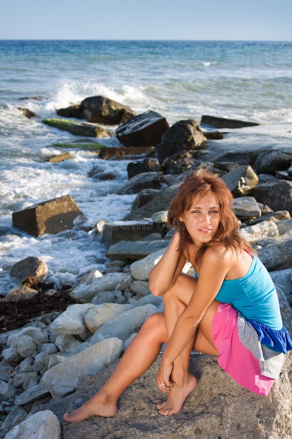 A young girl on a rock