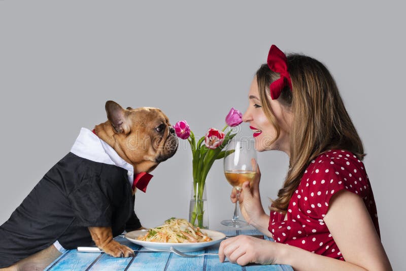 Young girl on romantic valentine`s day date with her dog french bulldog