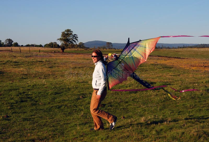 Young girl running with kite