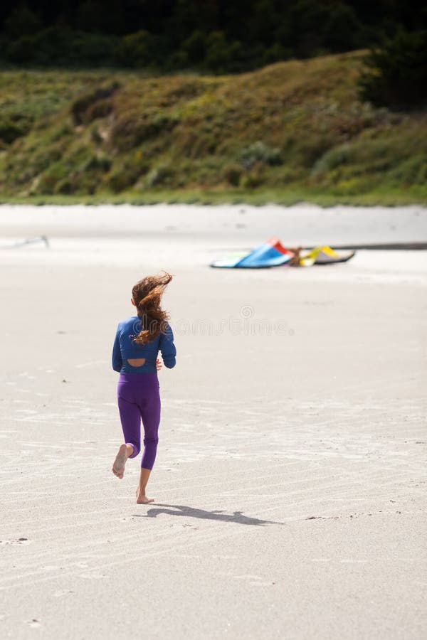 Young girl runs at the beach royalty free stock images