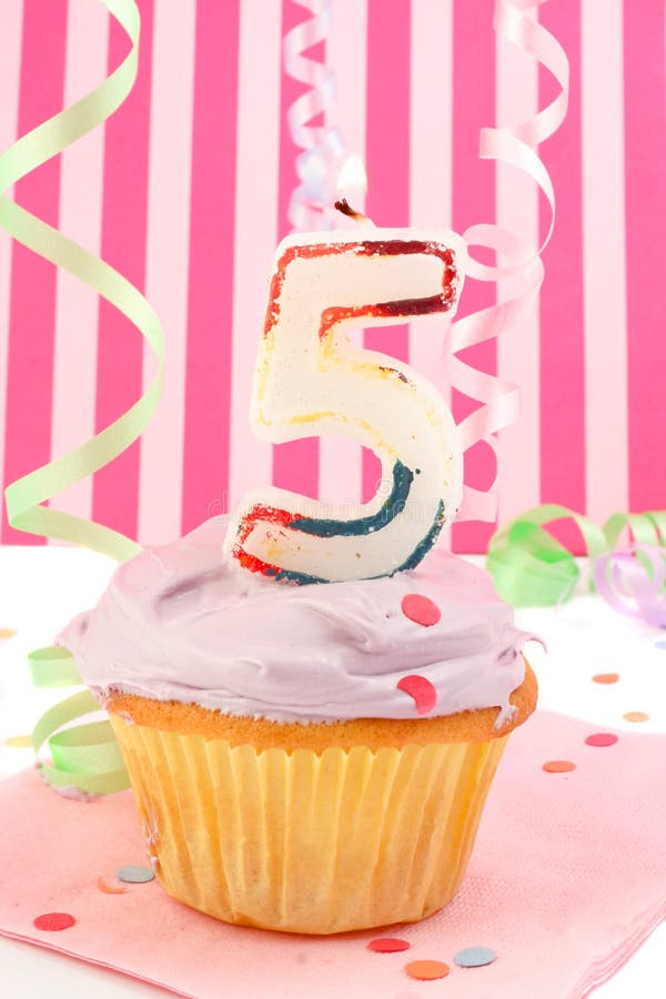 Young girl's birthday. Birthday cupcake with pink frosting and and decorative background celebrating child's fifth anniversary stock photos Young girl's birthday. Birthday cupcake with pink frosting and and decorative background celebrating child's fifth anniversary stock photos