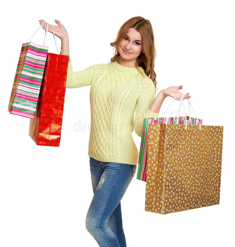 Young girl with shopping bag casual dressed jeans and a green sweater posing in studio on white background