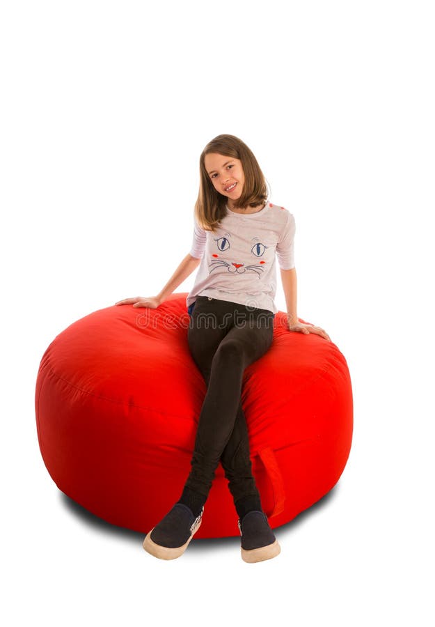 young girl sitting round shape red beanbag chair isolated white background 84661743