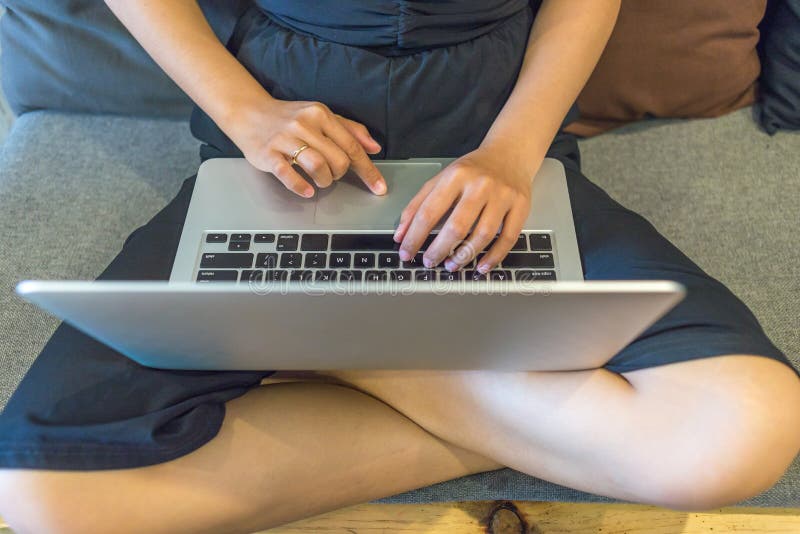 Young girl sitting on sofa and using laptop royalty free stock photo Young girl sitting on sofa and using laptop royalty free stock photo