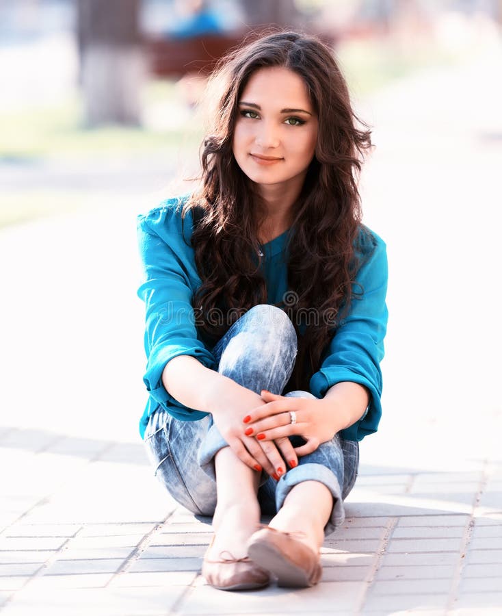 Young girl sitting on a way