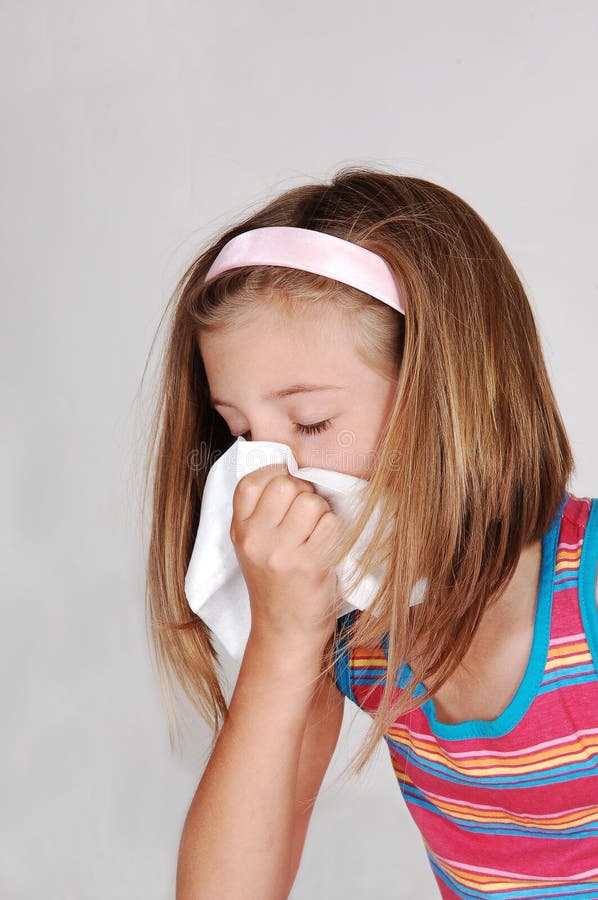 Young girl sneezing.