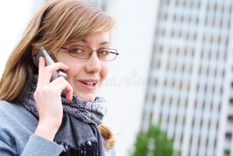 The young girl speaks by mobile phone. Business