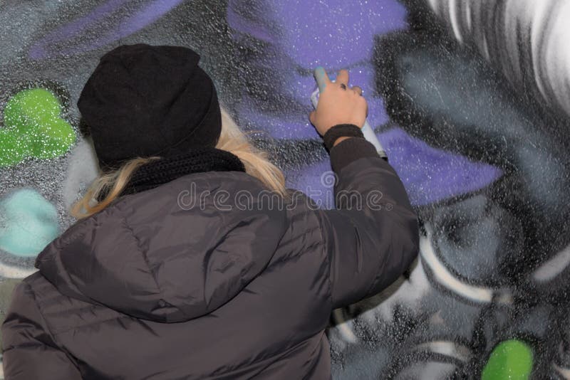 Young Girl Street Artist: Spraying on Public Urban City Wall stock photo Young Girl Street Artist: Spraying on Public Urban City Wall stock photo