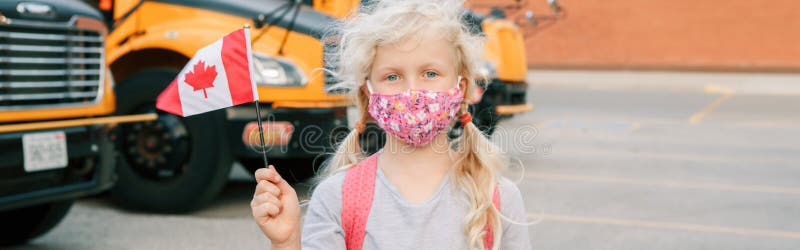 Young girl student in protective face mask with Canadian flag. Student kid by yellow school bus outdoor. Education and back to stock image Young girl student in protective face mask with Canadian flag. Student kid by yellow school bus outdoor. Education and back to stock image